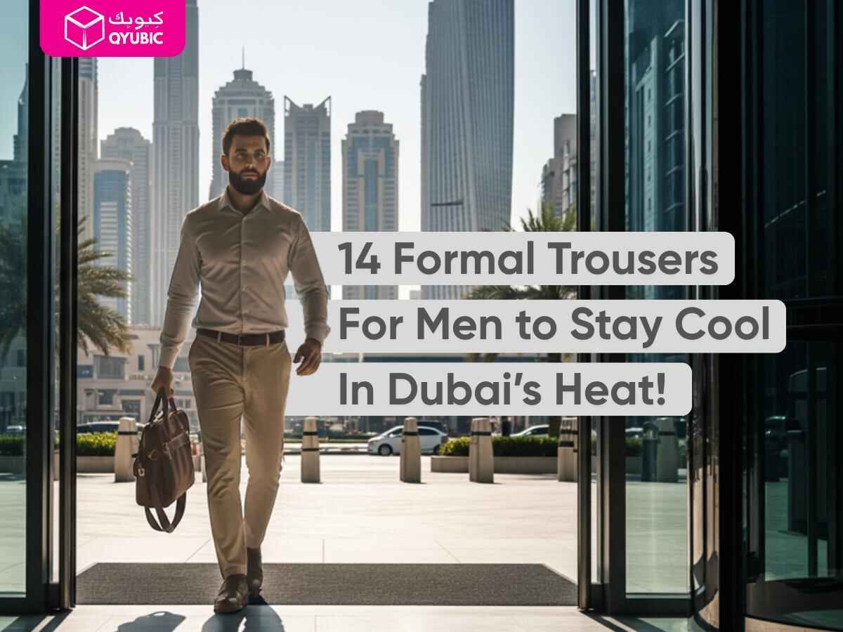 A stylish man with a beard, wearing a light-colored formal shirt and formal trousers, walks confidently through a modern glass building entrance, holding a brown leather bag. The text overlay reads "14 Formal Trousers For Men to Stay Cool In Dubai's Heat!". The image features a city skyline with tall buildings in the background, suggesting a business or urban setting.