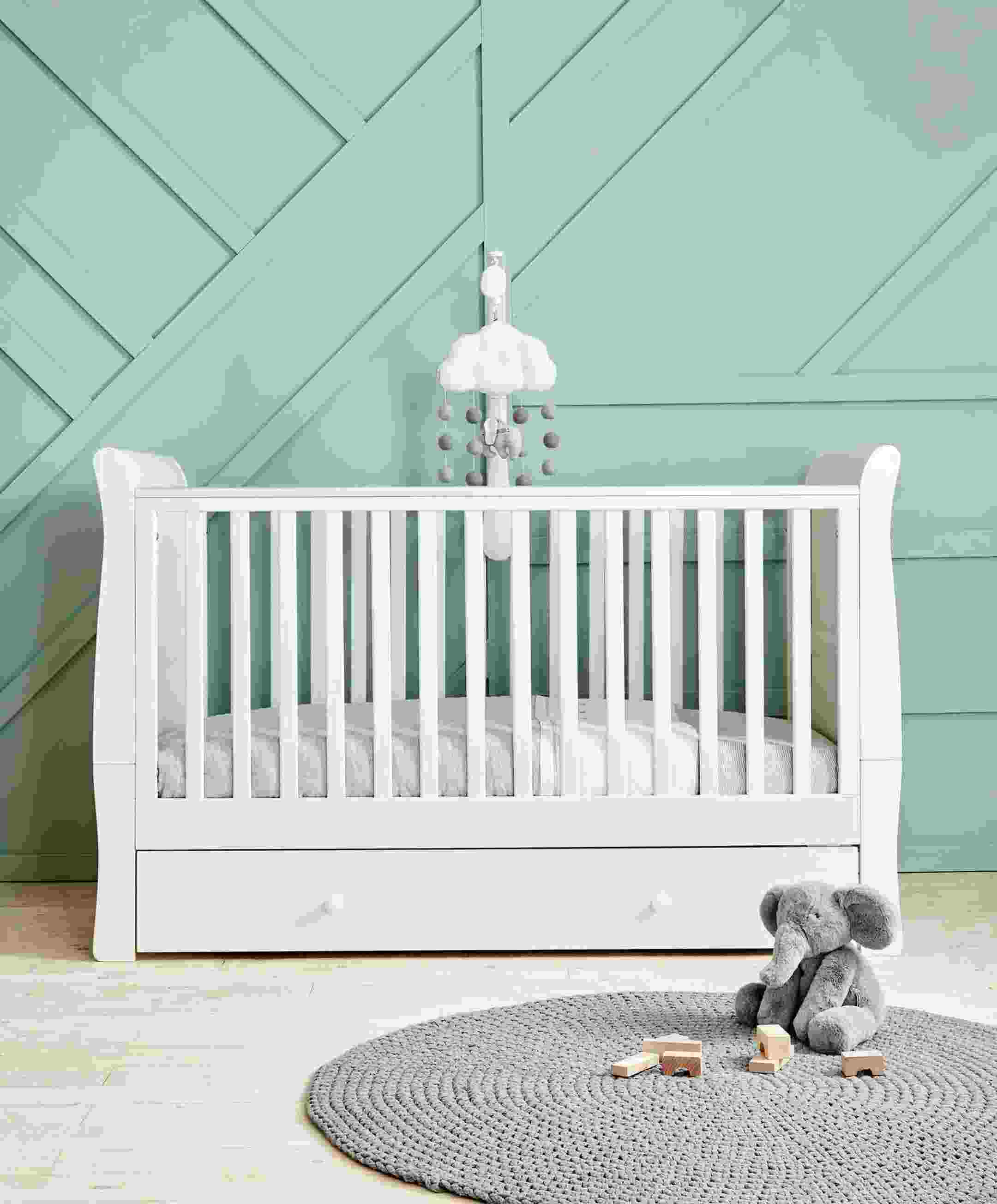 Mia Cot toddler bed in white with built-in under-bed storage, adjustable height settings, and dual teething rails – perfect baby cot with storage for infants up to 4 years.