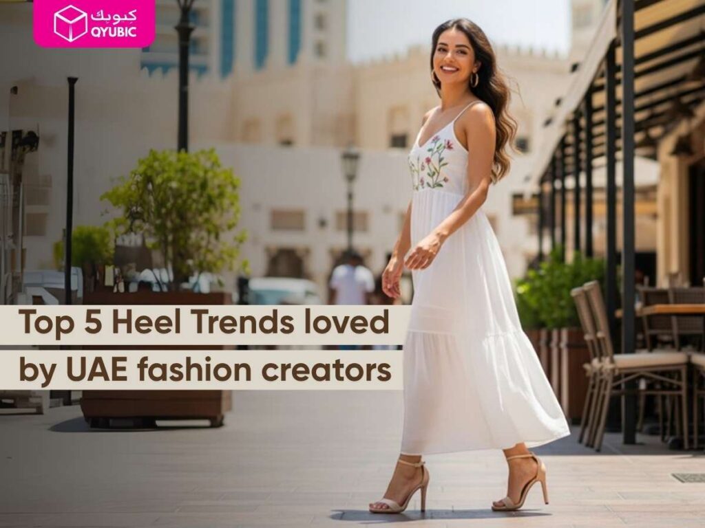 A smiling woman in a white midi dress walking outdoors in nude strappy heels, with text “Top 5 Heel Trends loved by UAE fashion creators” and Qyubic logo highlighting trendy heels.