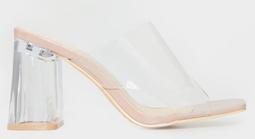 Nude mules with a flared clear block heel and wide PVC strap from PrettyLittleThing, offering both stability and sleek minimalism.
